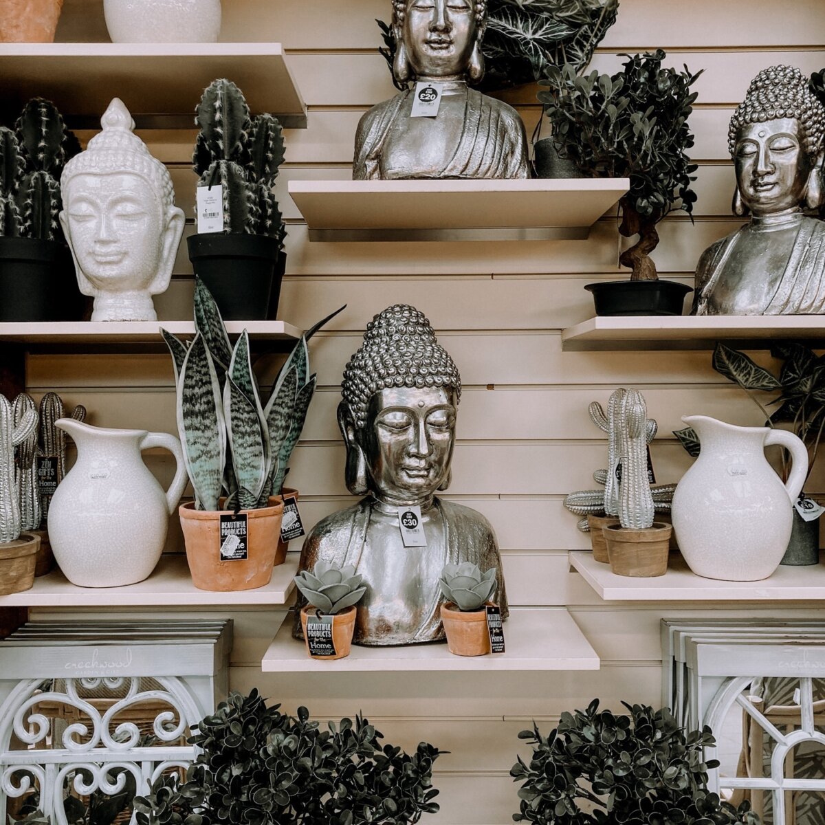 Store display mixing vases, statues, pitchers and plants in whites, greens, and silver