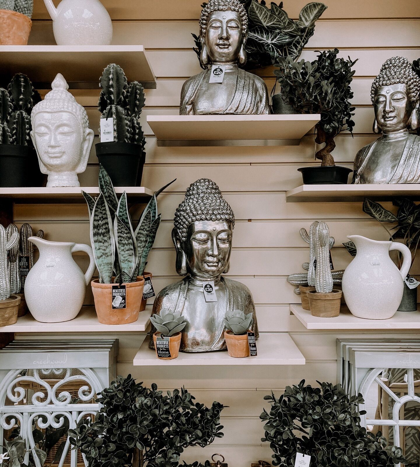 Store display mixing vases, statues, pitchers and plants in whites, greens, and silver