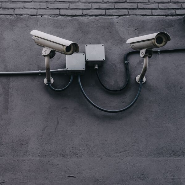 Two security cameras on side of a building