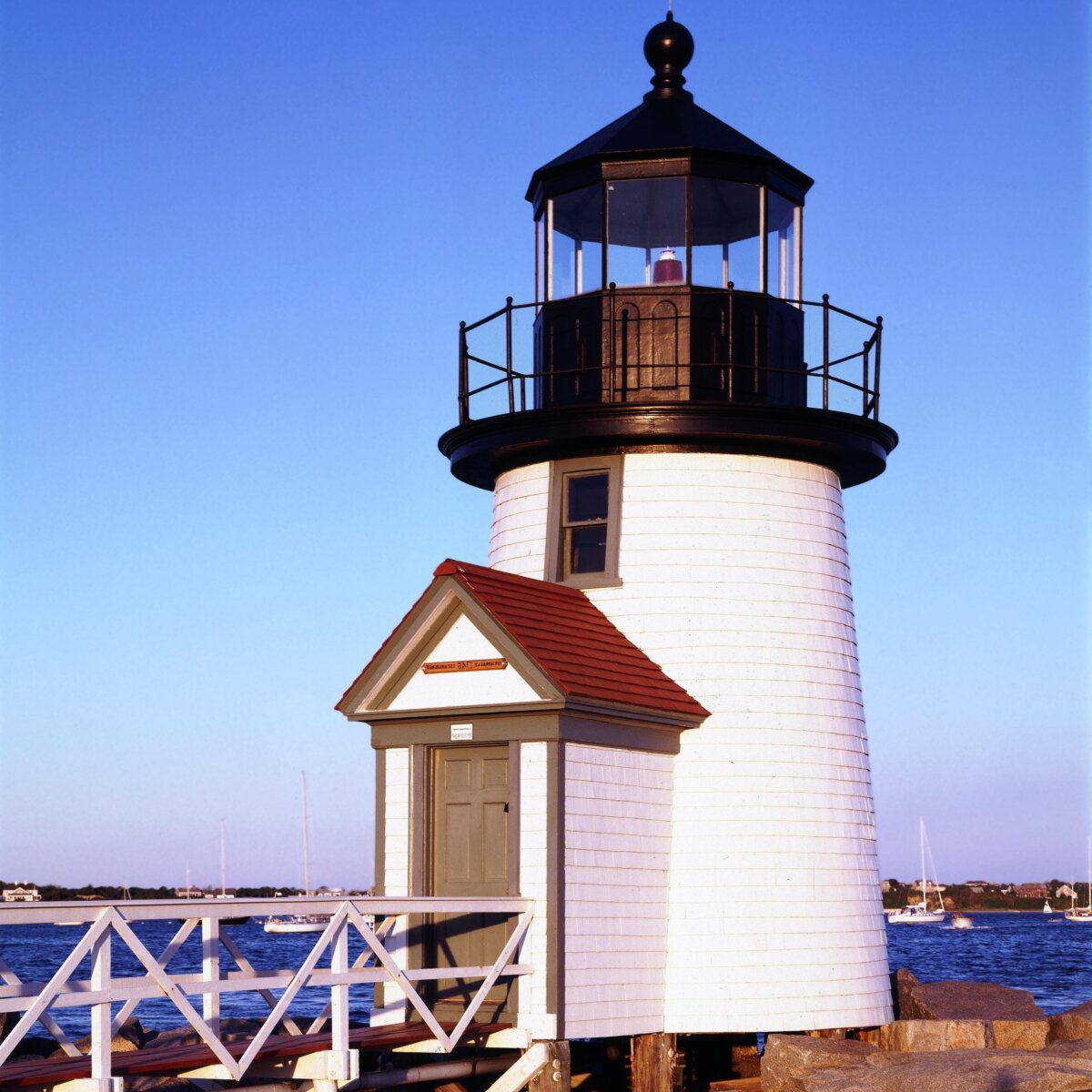 Old lighthouse with ocean behind on a nice sunny day.