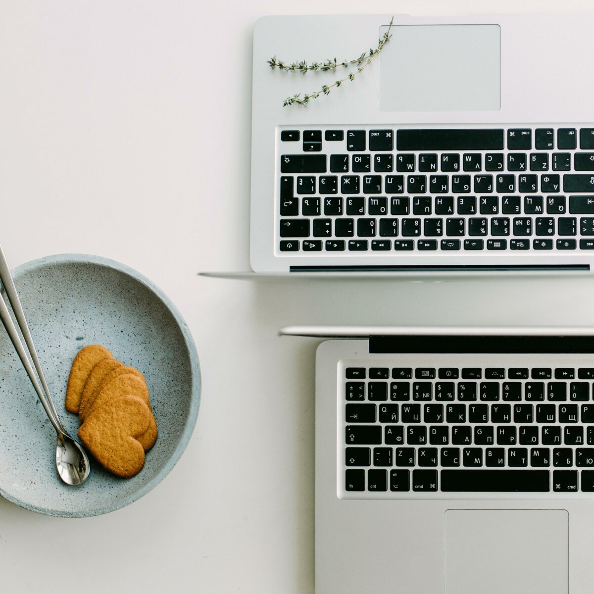 Two computers and a plate of cookies