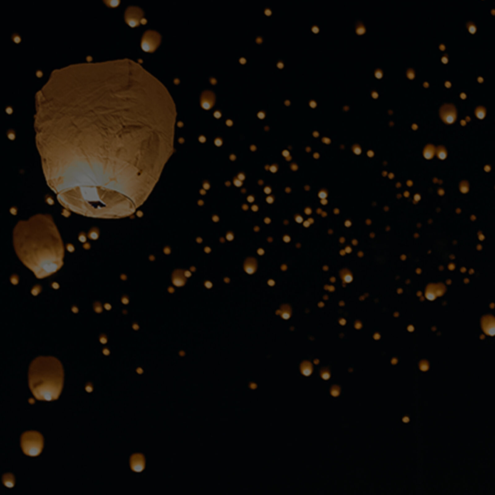 Reimagine website image showing memorial lanterns floating in sky